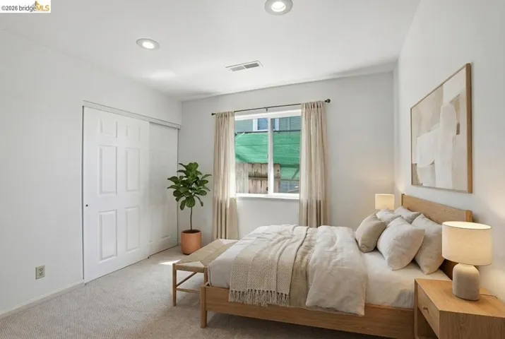 Carpeted bedroom featuring a closet and recessed lighting