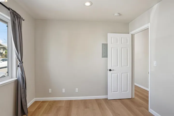 Spare room featuring light wood finished floors and electric panel