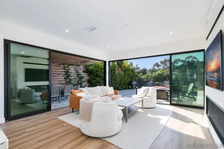 Spacious living room opening up to the back patio & heated pool!