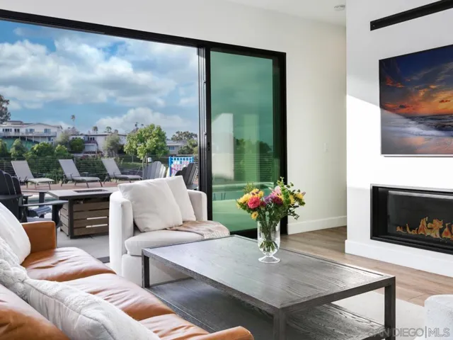 Spacious living room opening up to the back patio & heated pool!