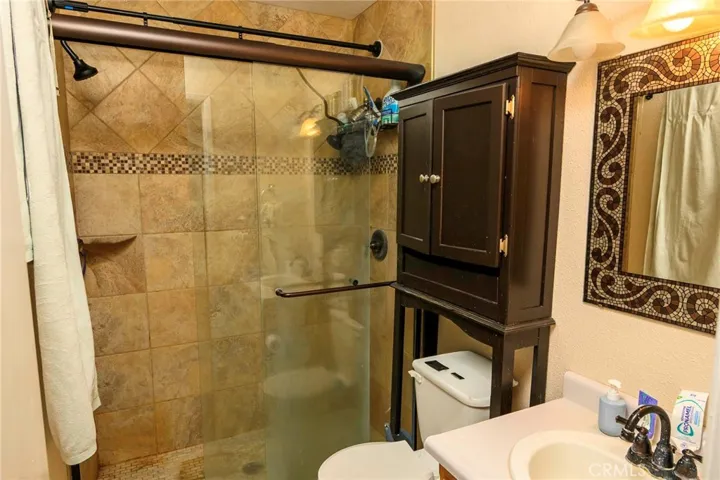 Tiled walk-in shower. Tiled flooring