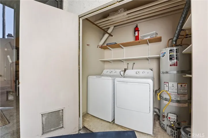Full sized washer and dryer along with water heater tucked away and accessiable thru the patio