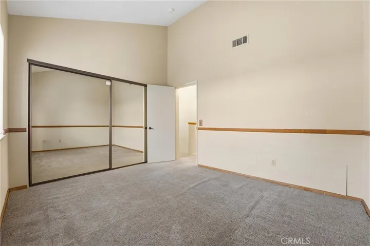 Second bedroom with oversized mirrored closet