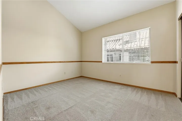 Second bedroom with vaulted ceilings and abundant natural light