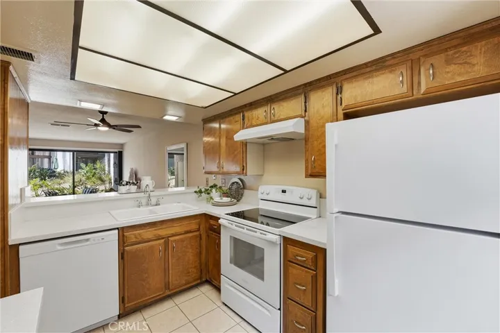 Kitchen is open to the dining area with a bright window to the front