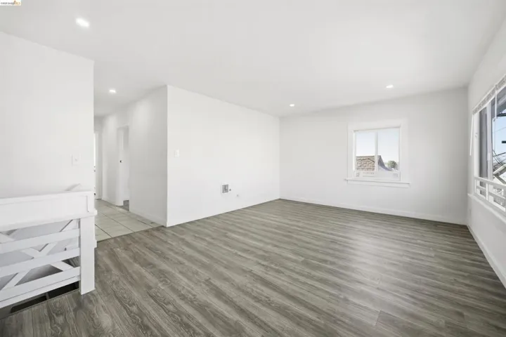 Spare room featuring recessed lighting and dark wood-type flooring