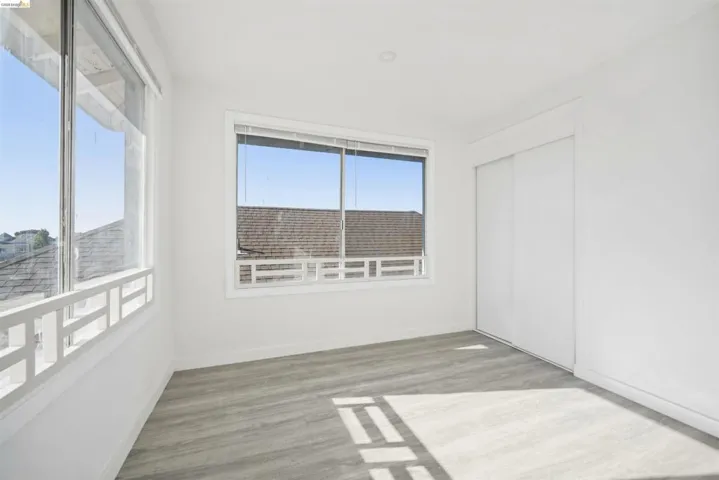 Unfurnished bedroom featuring light wood finished floors and a closet