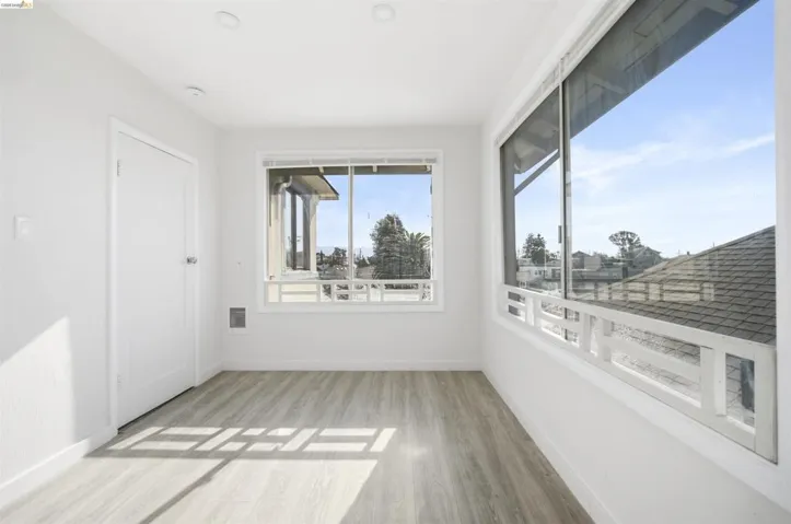 Spare room featuring light wood finished floors and baseboards