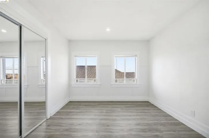 Unfurnished bedroom featuring a closet, wood finished floors, and recessed lighting
