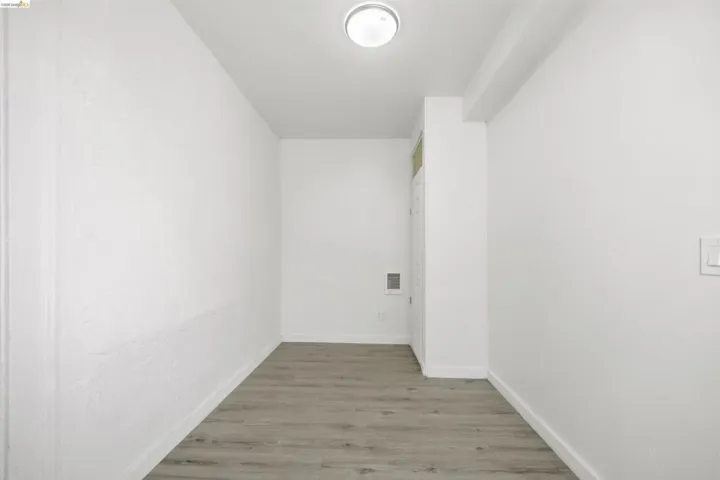 Laundry room with light wood-style flooring and baseboards
