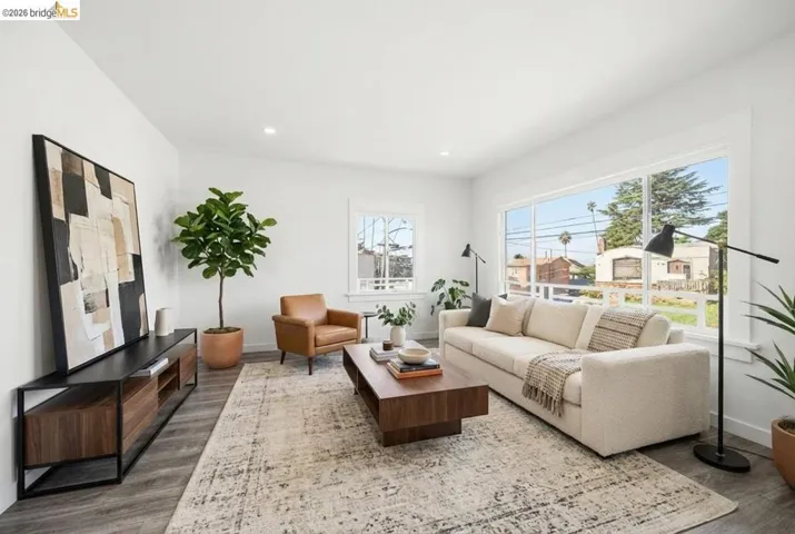 Living area with wood finished floors and recessed lighting