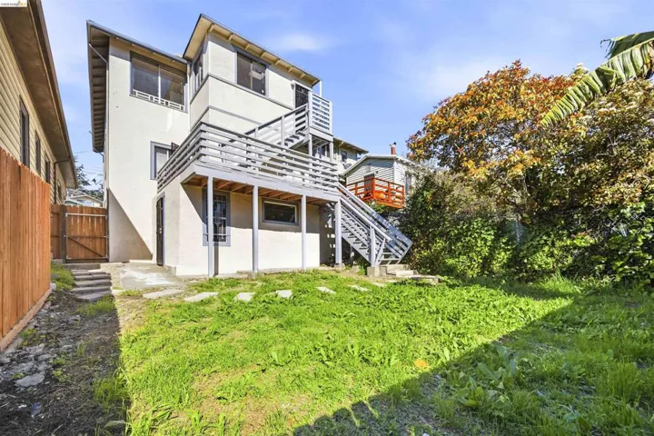 Back of property with stucco siding, a fenced backyard, and a patio