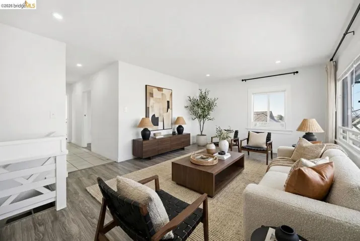 Living area with wood finished floors and recessed lighting