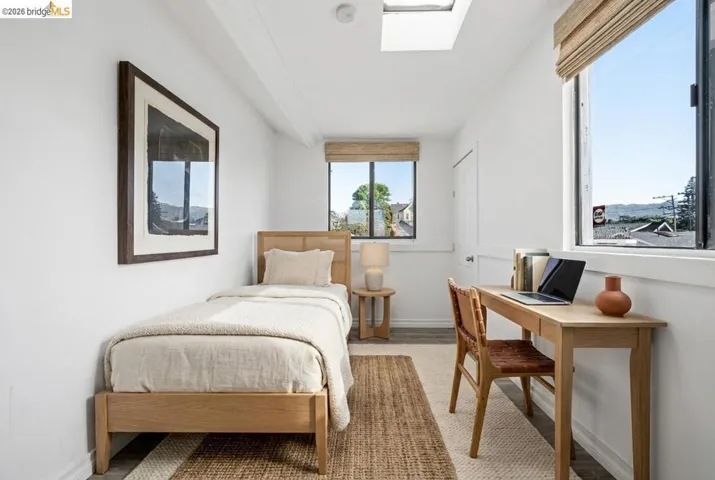 Bedroom with baseboards and a skylight