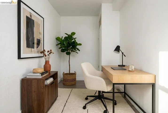 Office space with light wood-style floors and baseboards