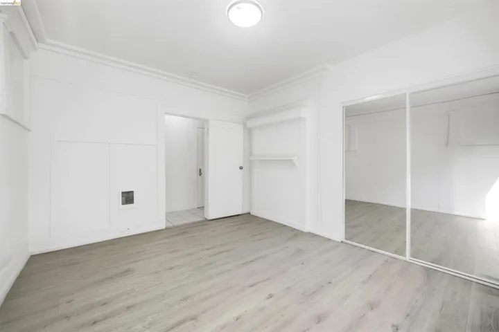 Unfurnished bedroom with light wood finished floors and a closet