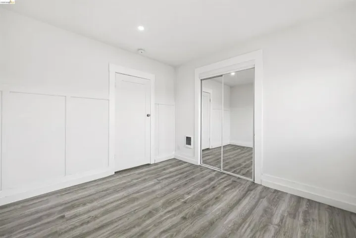 Unfurnished bedroom with wood finished floors, a closet, and recessed lighting