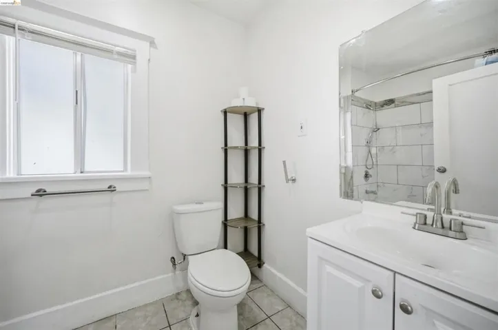 Full bathroom featuring a shower, vanity, and light tile patterned floors