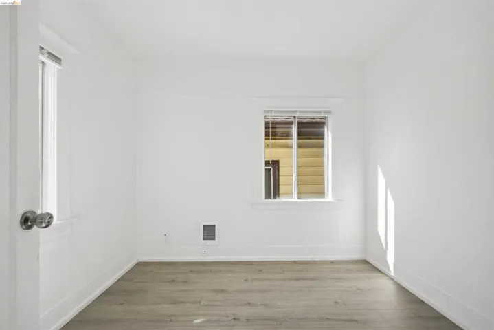 Unfurnished room featuring light wood-type flooring and baseboards
