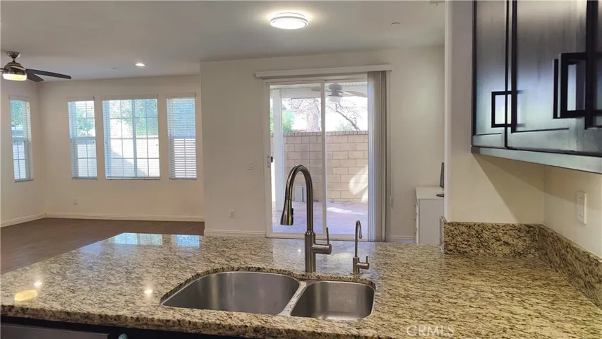 Kitchen view of dining area and living room
