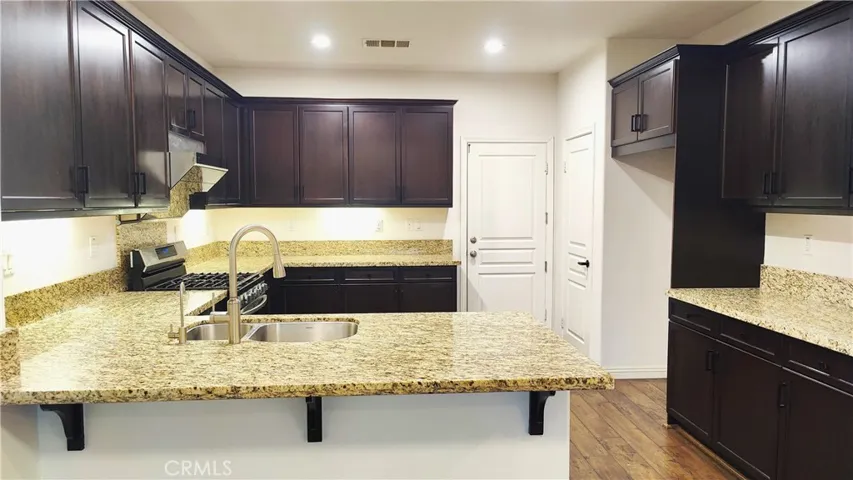 View of kitchen and pantry door and door to 2 car garage