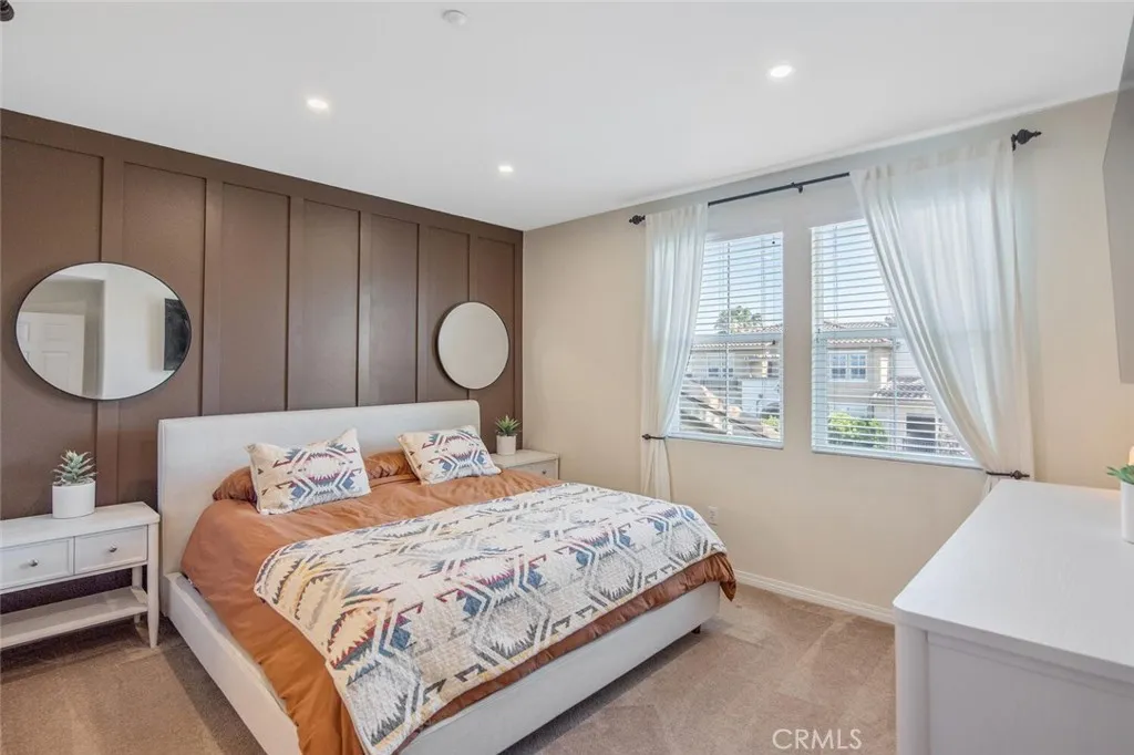 Bedroom 1 (Primary) with eastern-facing windows bring early morning light