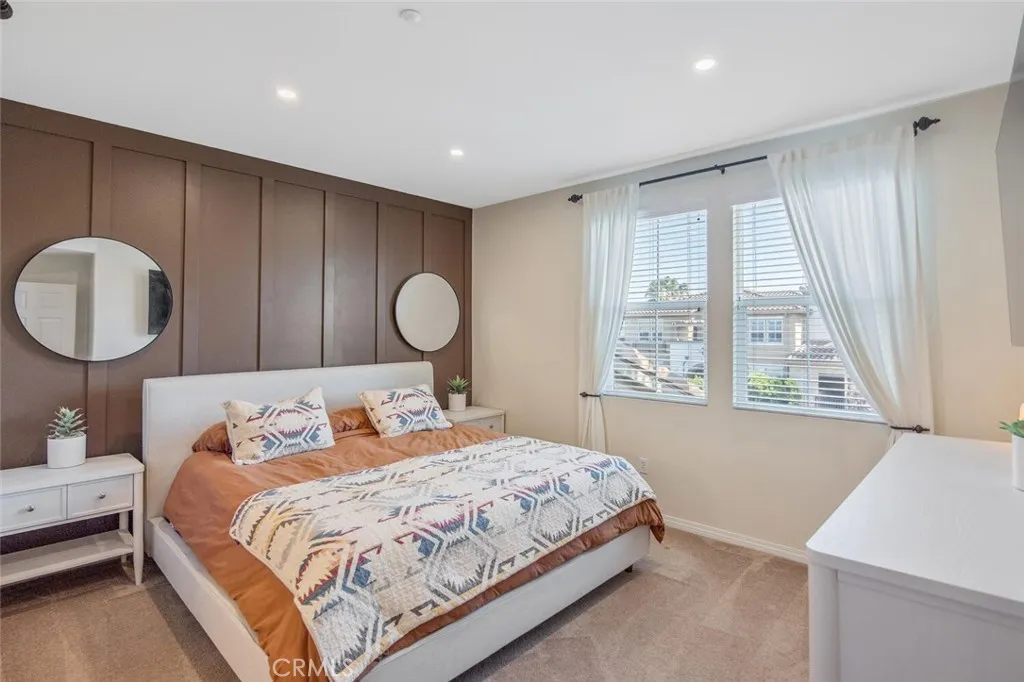 Bedroom 1 (Primary) with eastern-facing windows bring early morning light