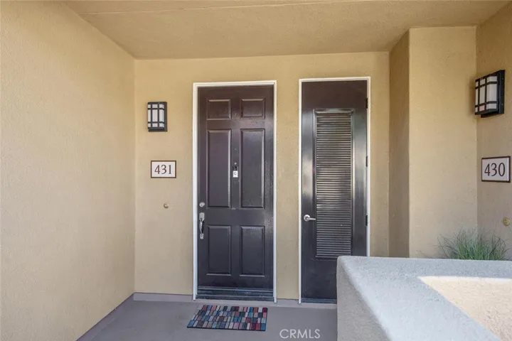 Front door (L) with adjacent exterior hot water heater closet (R)