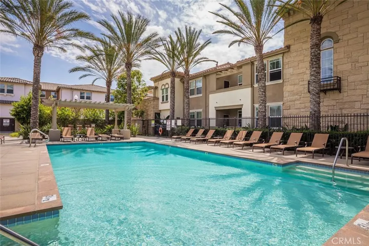 Association pool with lounge chairs & palms