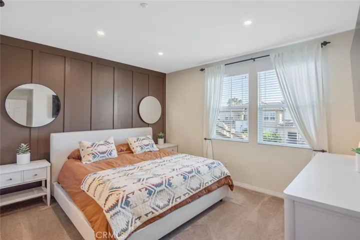Bedroom 1 (Primary) with eastern-facing windows bring early morning light