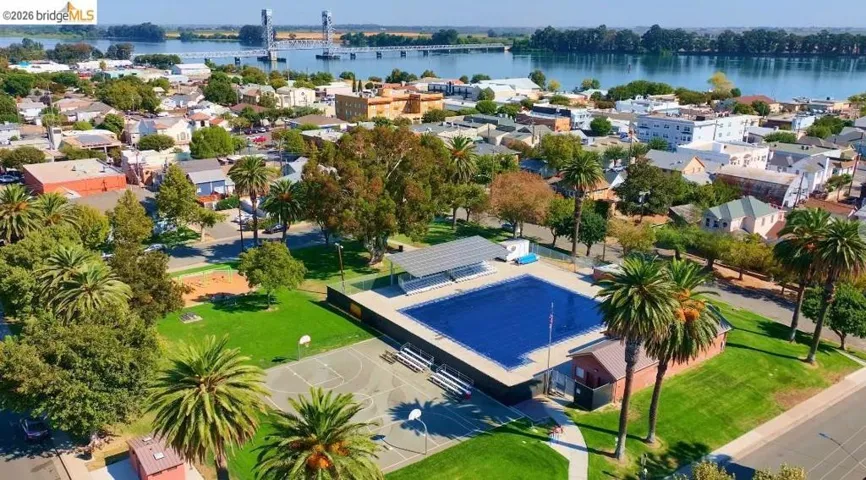 Aerial view of residential area featuring a nearby body of water