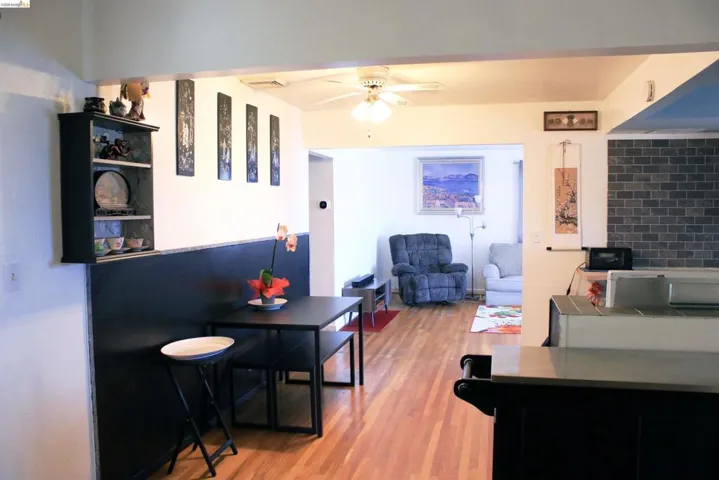 Dining room with light wood finished floors and ceiling fan