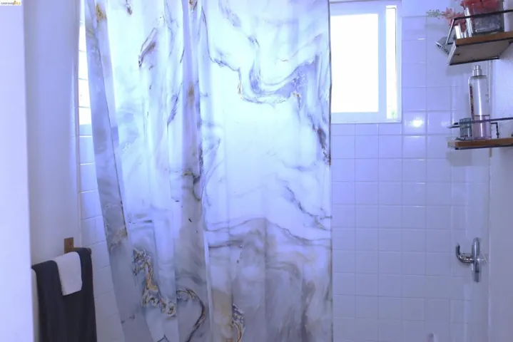 Bathroom with curtained shower