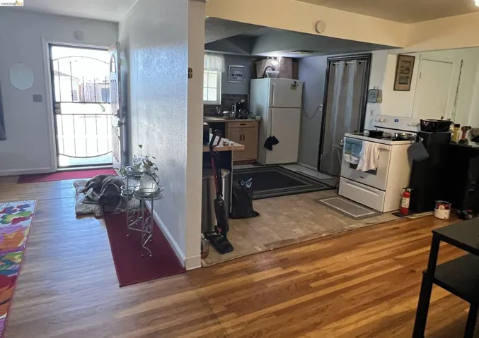 Kitchen featuring white appliances and light wood-style flooring