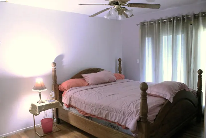 Bedroom with wood finished floors and ceiling fan