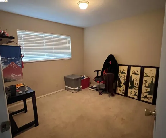 Misc room with light carpet and baseboards