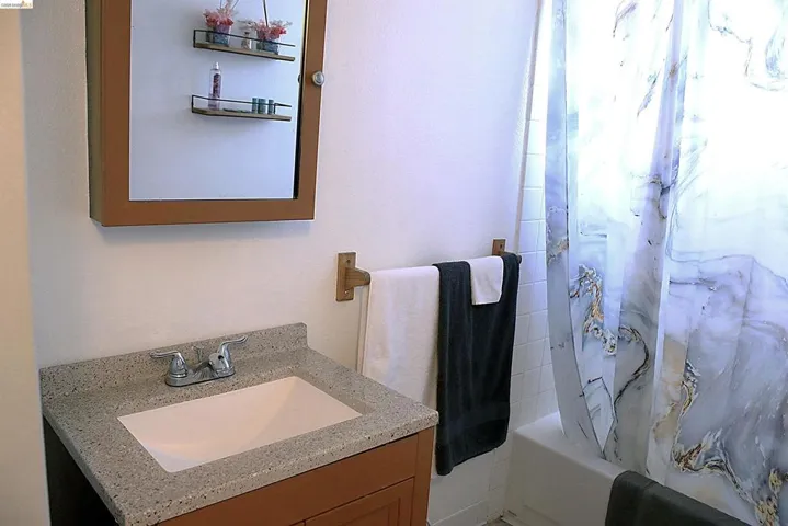 Bathroom featuring vanity and shower / tub combo