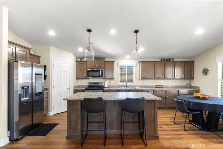 Kitchen with large island, stainless steel appliances, and ample storage
