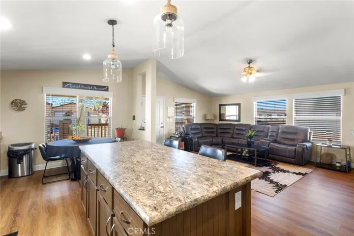 Open concept kitchen flowing into living and dining areas