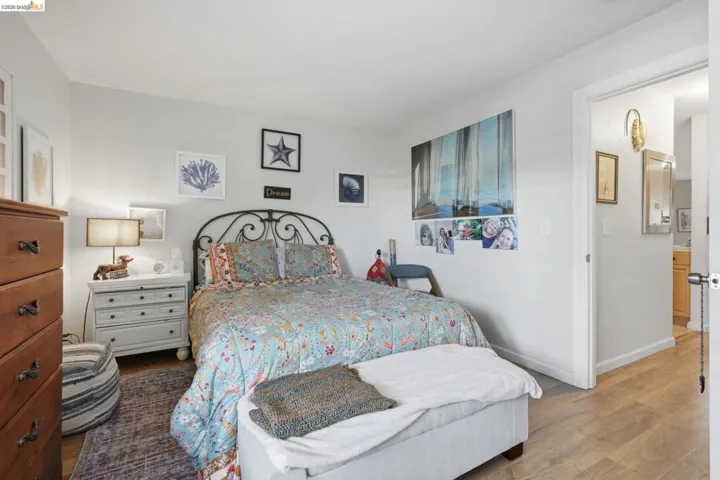 Bedroom featuring wood finished floors and baseboards