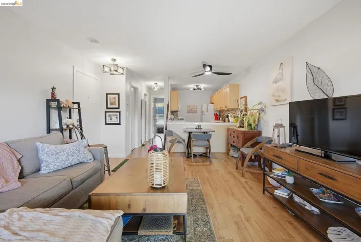 Living room featuring ceiling fan and light wood finished floors