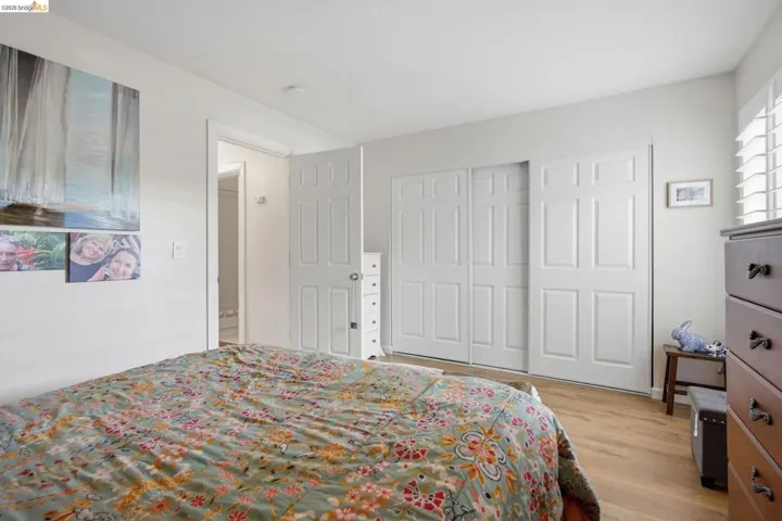 Bedroom featuring light wood-type flooring and a closet