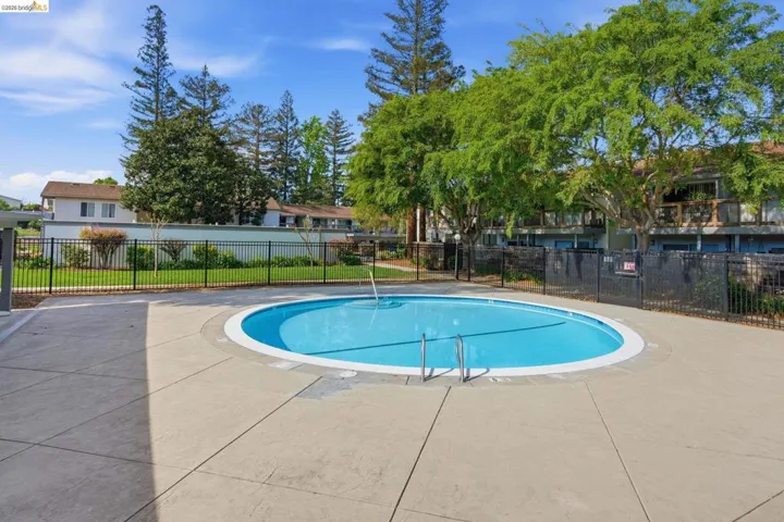 Community pool featuring a patio