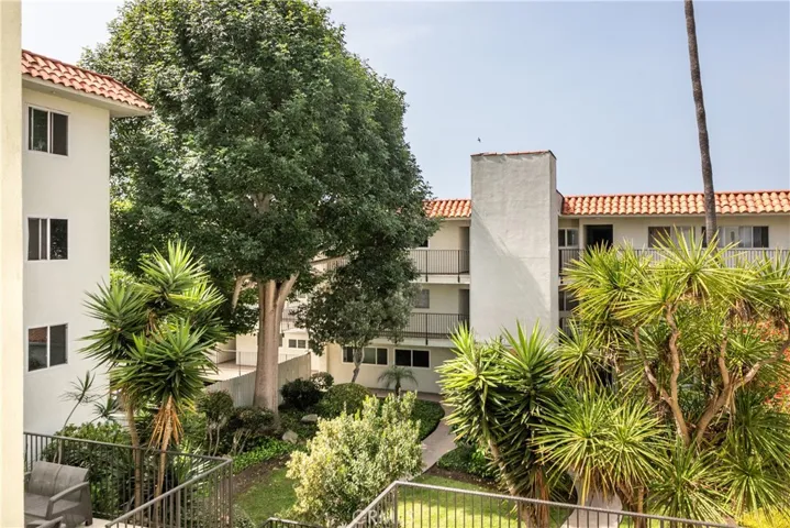 Set around a lush, tree-filled courtyard featuring mature lemon trees, vibrant landscaping, and frequent hummingbird visits, the community provides a peaceful retreat rarely found along the coast.