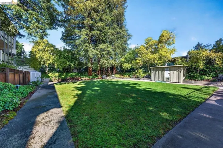 fenced yard with a storage unit