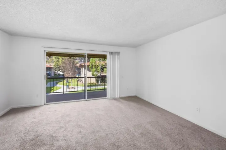 Spacious living room & private balcony overlooking courtyard