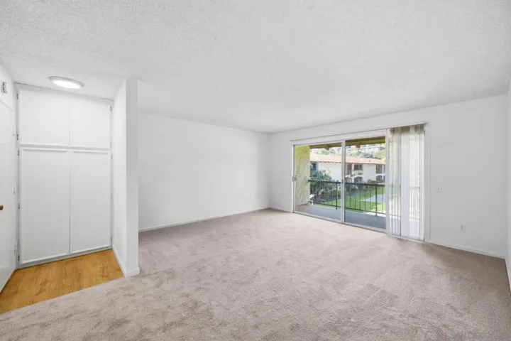 Spacious living room & private balcony overlooking courtyard