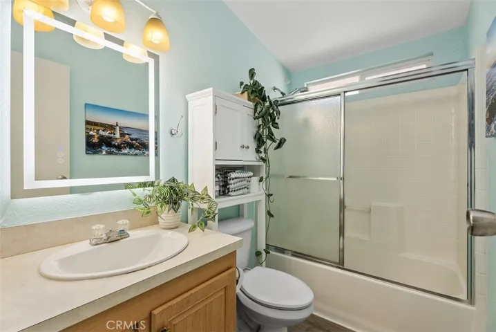 Guest bathroom w/tub shower. Lighted mirror