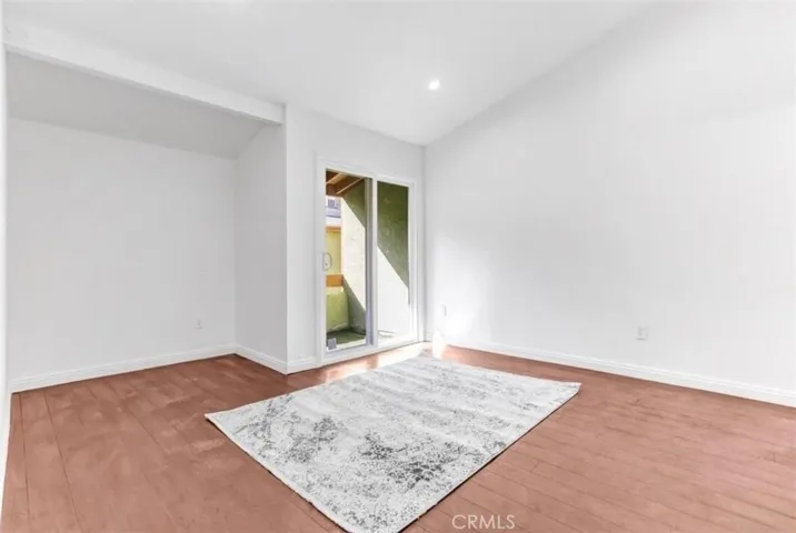 Updated Bedroom (2) offering a full bath, private balcony, high ceilings, and recessed lighting throughout.