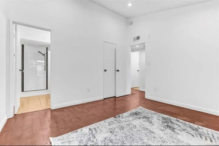 Bedroom (2) Beautifully updated, featuring a full bath, private balcony, high ceilings, and recessed lighting.